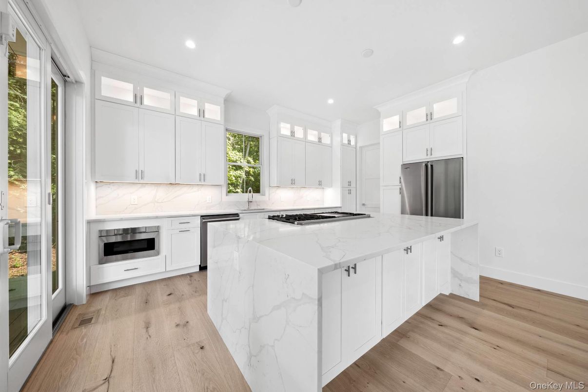 Interior, Kitchen, Marble Walls, Recessed Lighting, Stainless Steel Appliances, Wood Texture Flooring
