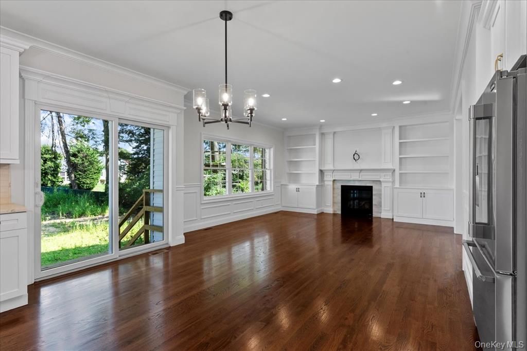 Chandelier, Empty room, Fireplace, Interior, Pendant Lights, Recessed Lighting, Wood Texture Flooring