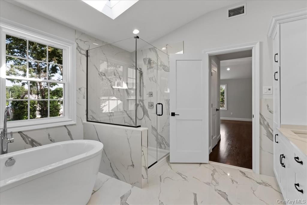 Bathroom, Free Standing Baths, Glass Shower, Interior, Marble, Marble Walls, Recessed Lighting, Wood Texture Flooring
