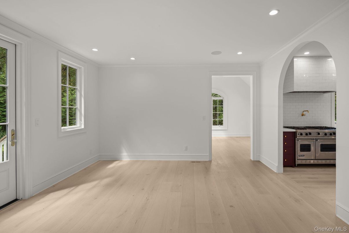 Empty room, Interior, Kitchen, Recessed Lighting, Stainless Steel Appliances, Wood Texture Flooring