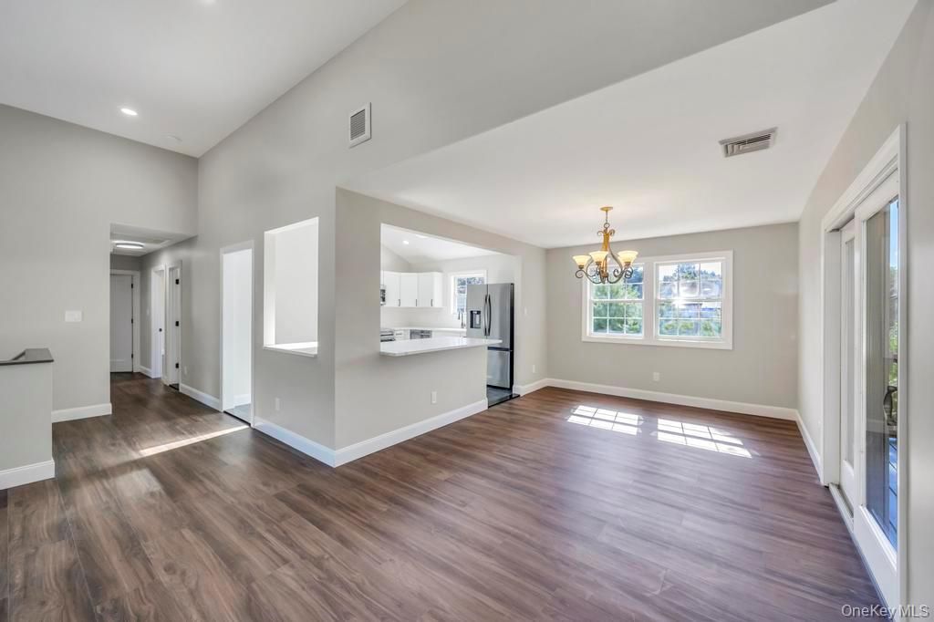 Chandelier, Empty room, Interior, Kitchen, Recessed Lighting, Stainless Steel Appliances, Wood Texture Flooring