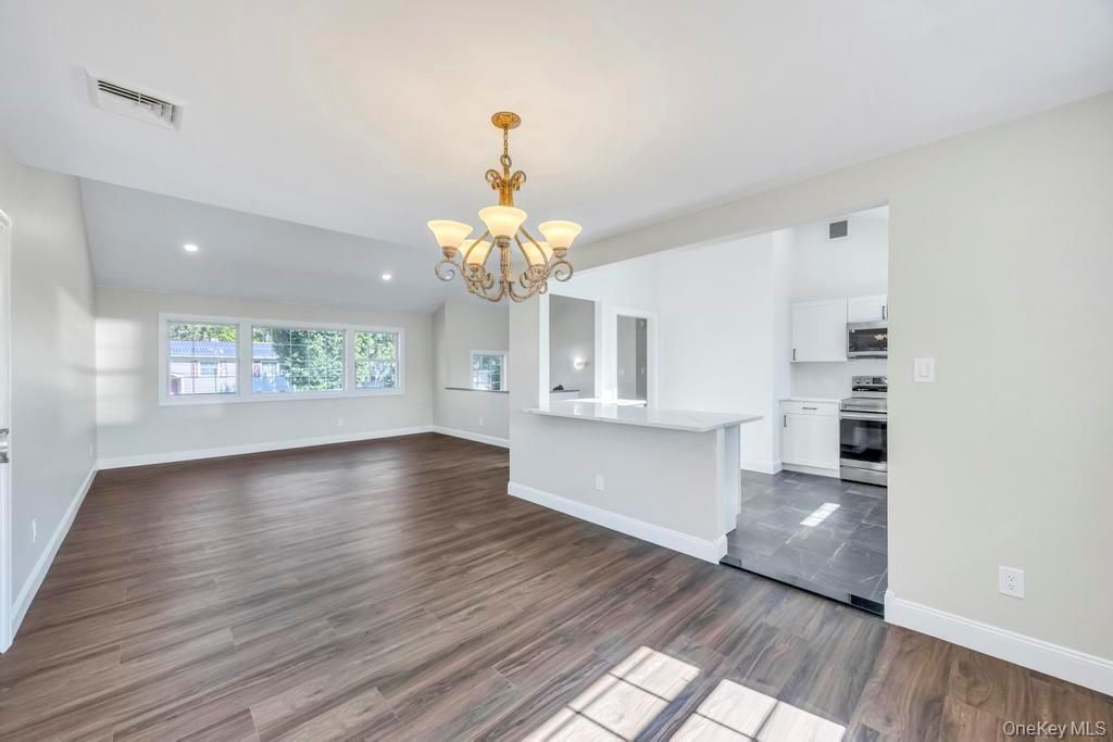Chandelier, Empty room, Interior, Kitchen, Recessed Lighting, Stainless Steel Appliances, Wood Texture Flooring