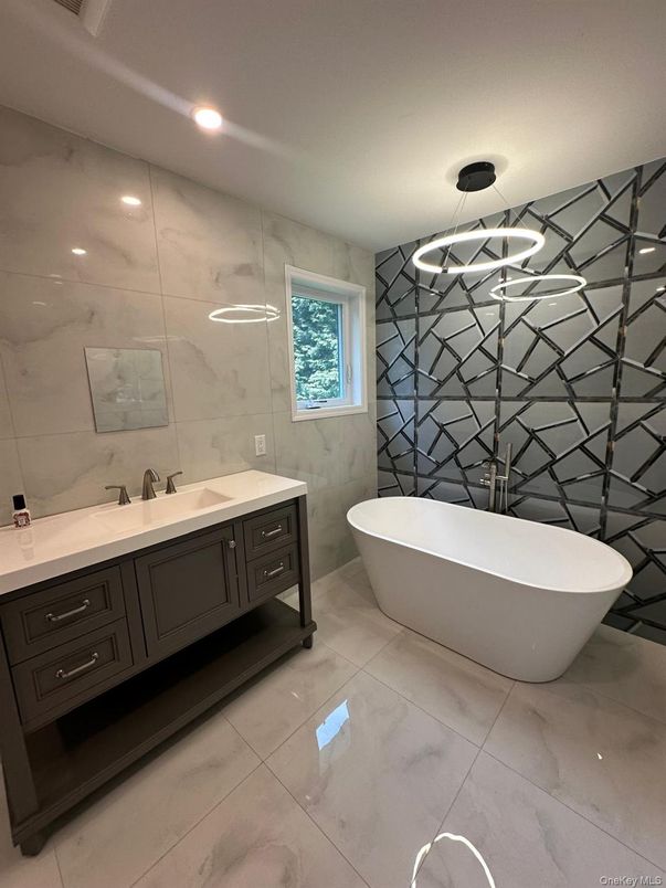 Bathroom, Dual Sink Vanities, Free Standing Baths, Interior, Marble Walls, Pendant Lights, Recessed Lighting