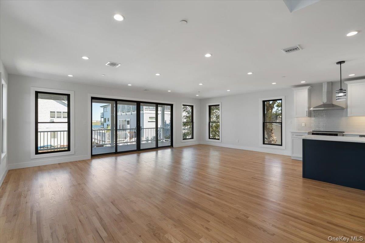 Empty room, Interior, Kitchen, Pendant Lights, Recessed Lighting, Stainless Steel Appliances, Wood Texture Flooring