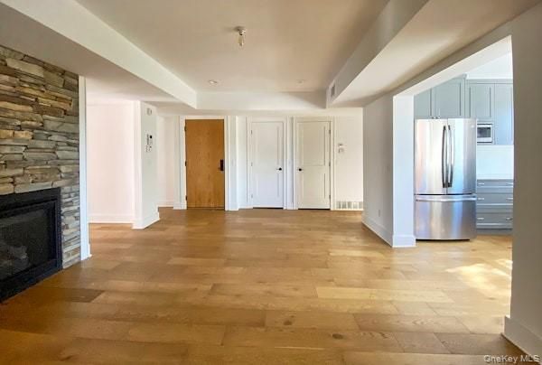 Empty room, Fireplace, Interior, Kitchen, Recessed Lighting, Stone Walls, Wood Texture Flooring