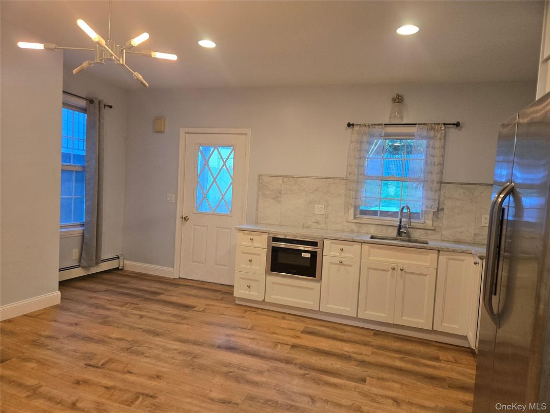 Interior, Kitchen, Marble Walls, Pendant Lights, Recessed Lighting, Stainless Steel Appliances, Wood Texture Flooring