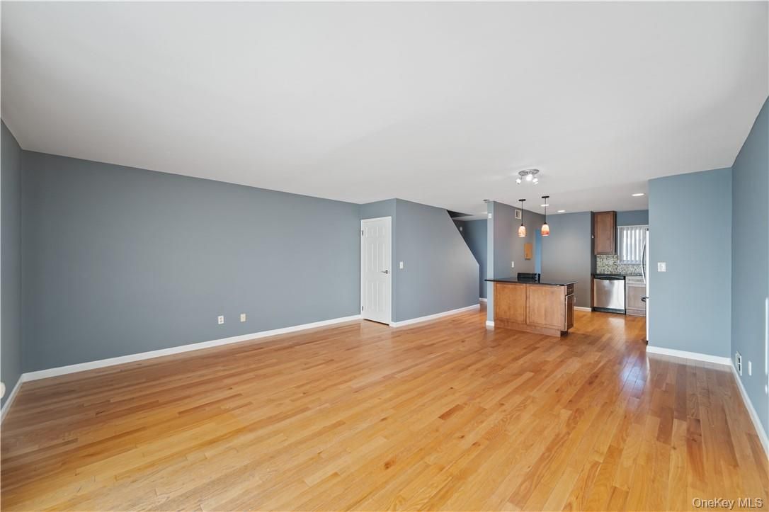 Empty room, Interior, Kitchen, Pendant Lights, Recessed Lighting, Stainless Steel Appliances, Wood Texture Flooring