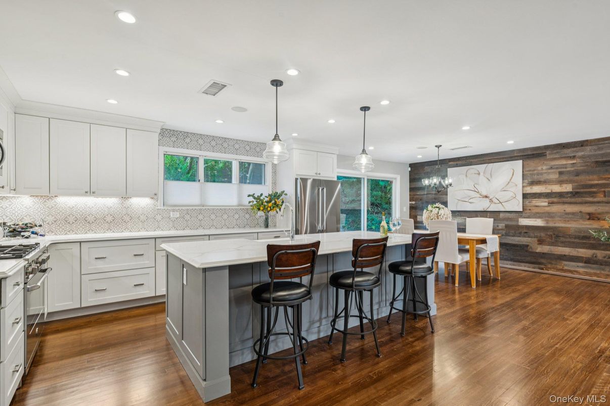 Dining room, Interior, Kitchen, Pendant Lights, Recessed Lighting, Stainless Steel Appliances, Wood Texture Flooring, Wooden Walls
