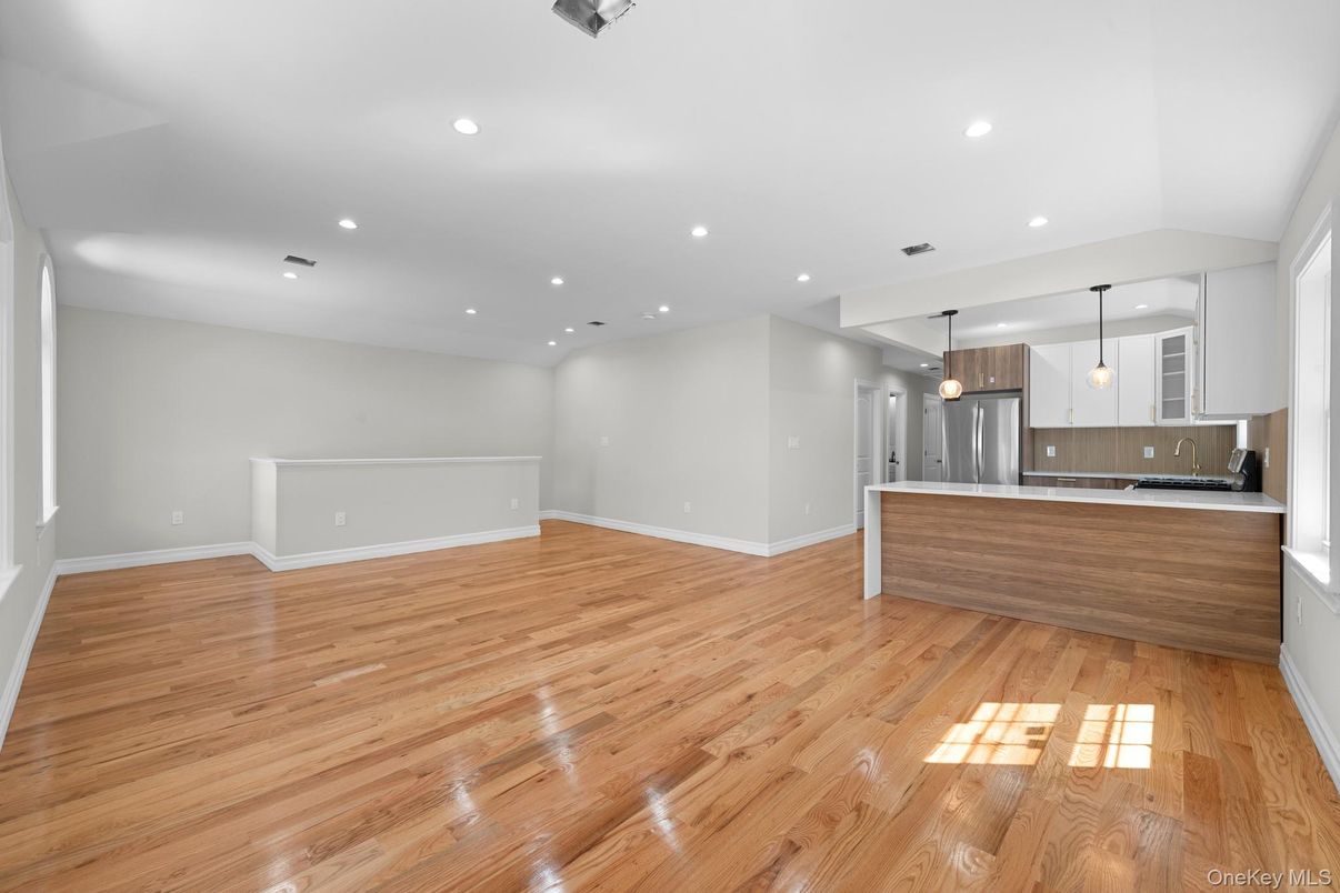 Empty room, Interior, Kitchen, Pendant Lights, Recessed Lighting, Stainless Steel Appliances, Wood Texture Flooring