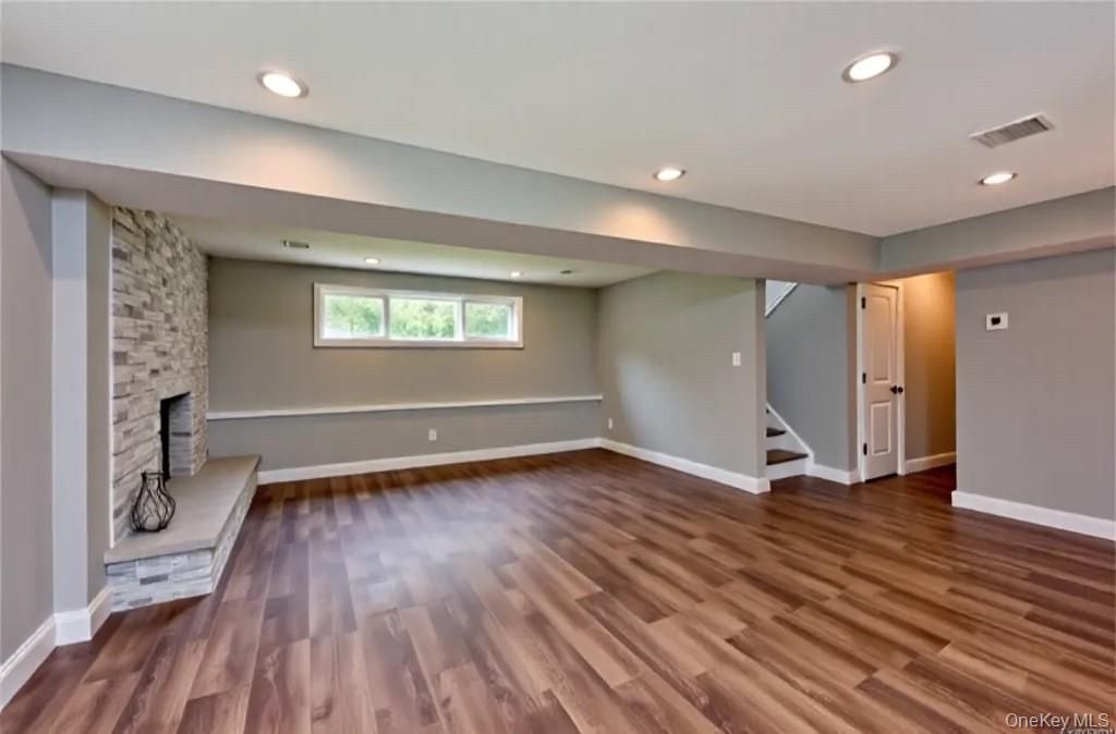Empty room, Fireplace, Interior, Recessed Lighting, Stone Walls, Wood Texture Flooring