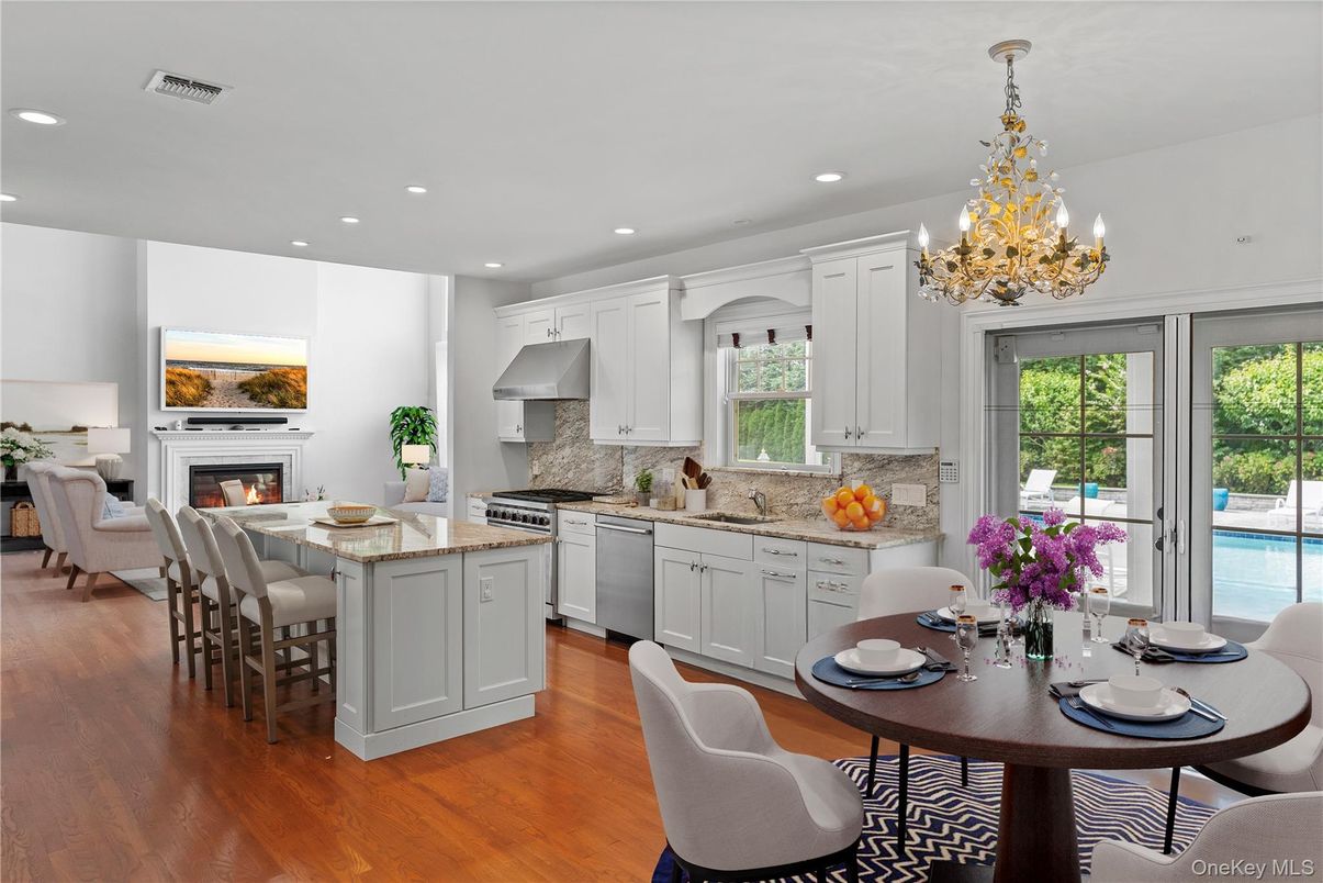 Chandelier, Dining room, Fireplace, Interior, Kitchen, Recessed Lighting, Stainless Steel Appliances, Wood Texture Flooring