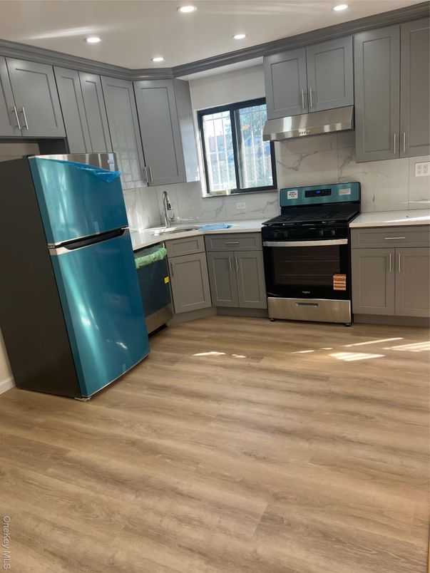 Interior, Kitchen, Marble Walls, Recessed Lighting, Stainless Steel Appliances, Wood Texture Flooring