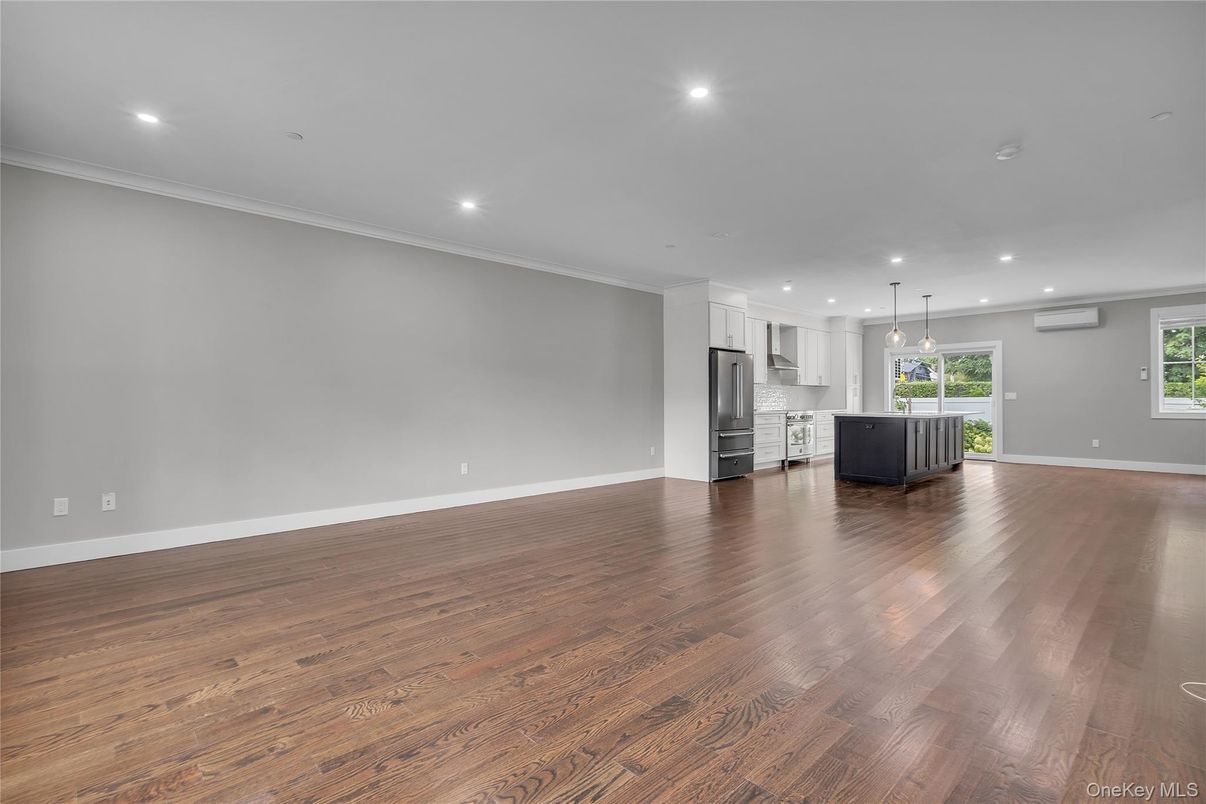 Empty room, Interior, Kitchen, Pendant Lights, Recessed Lighting, Stainless Steel Appliances, Wood Texture Flooring