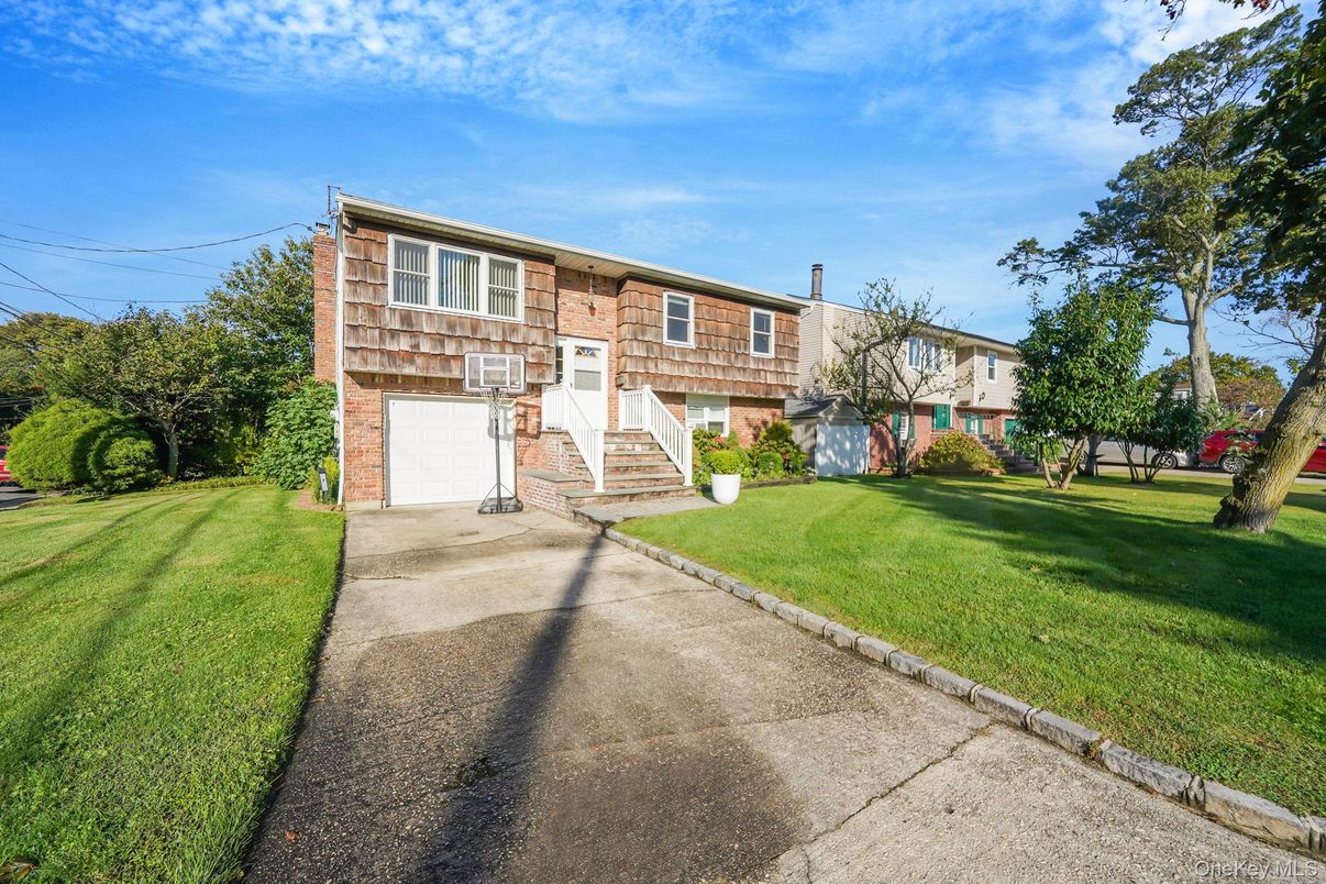 Attached, Backyard, Exterior, Facade, Brick Facade, Raised Ranch