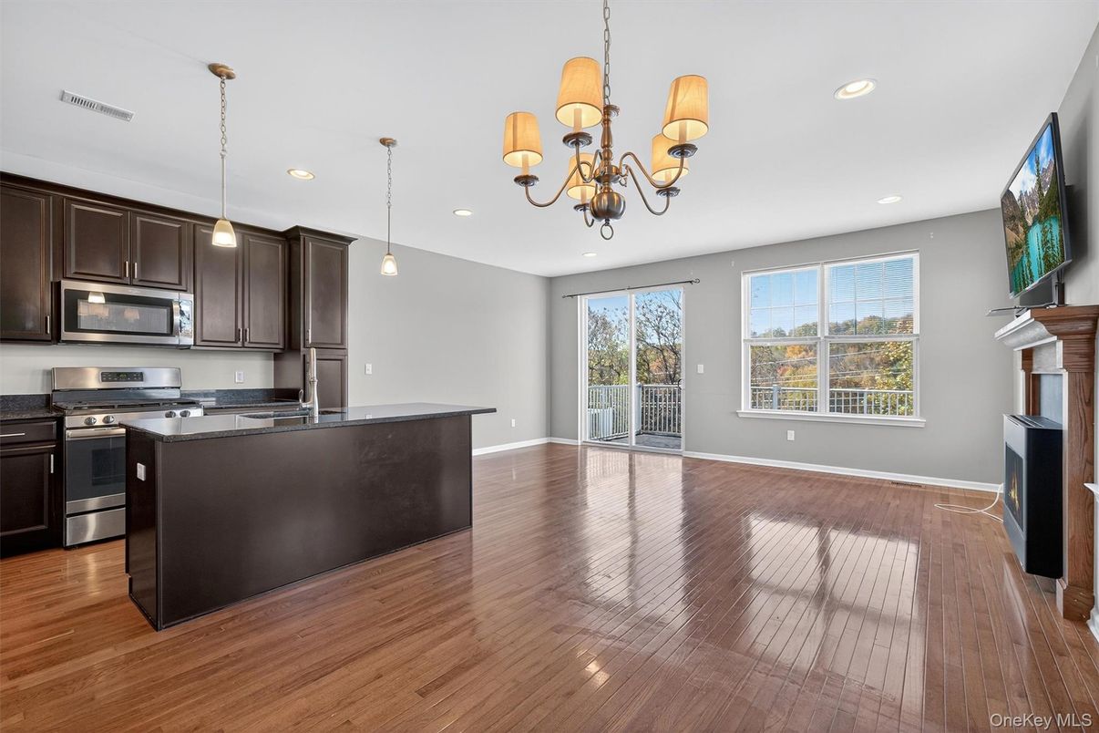 Chandelier, Fireplace, Interior, Kitchen, Pendant Lights, Recessed Lighting, Stainless Steel Appliances, Wood Texture Flooring