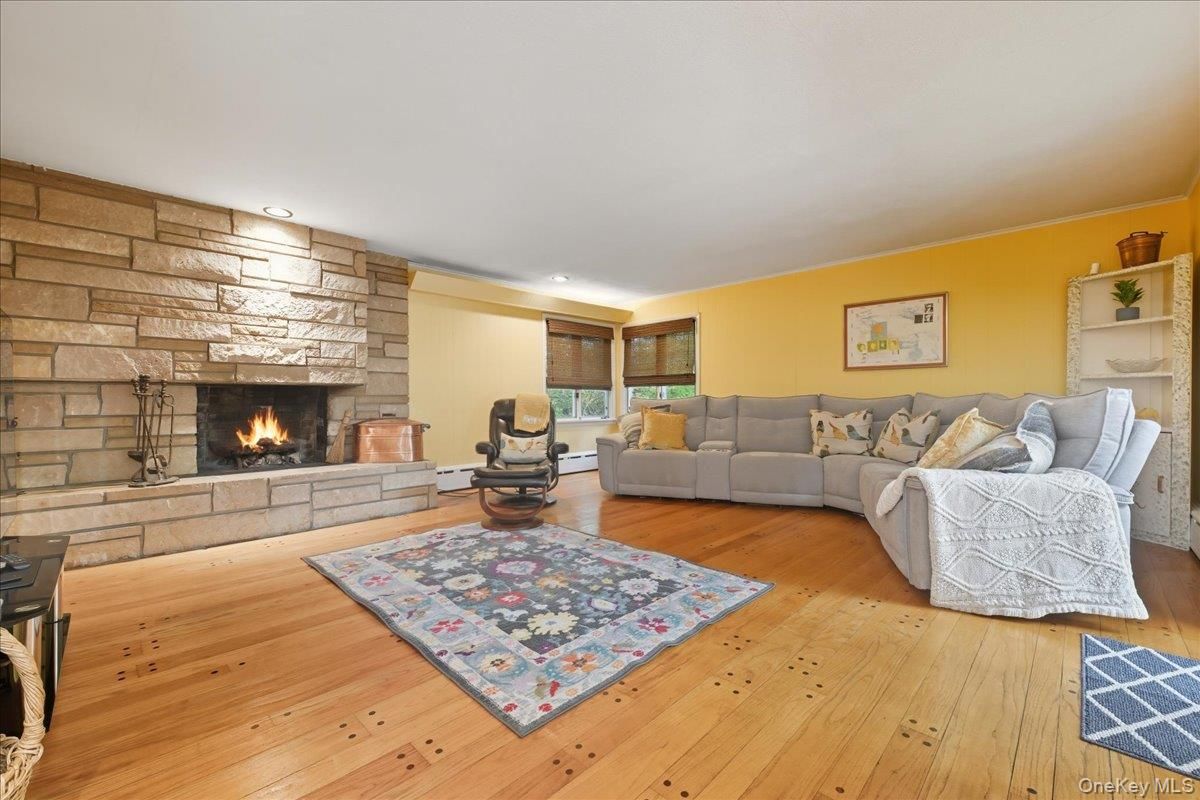 Fireplace, Interior, Living room, Recessed Lighting, Stone Walls, Wood Texture Flooring