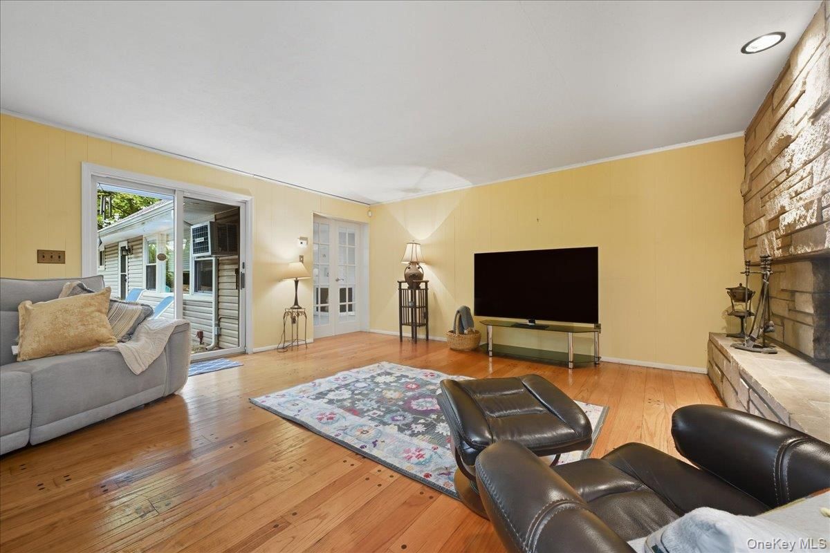 Fireplace, Interior, Living room, Recessed Lighting, Stone Walls, Wood Texture Flooring