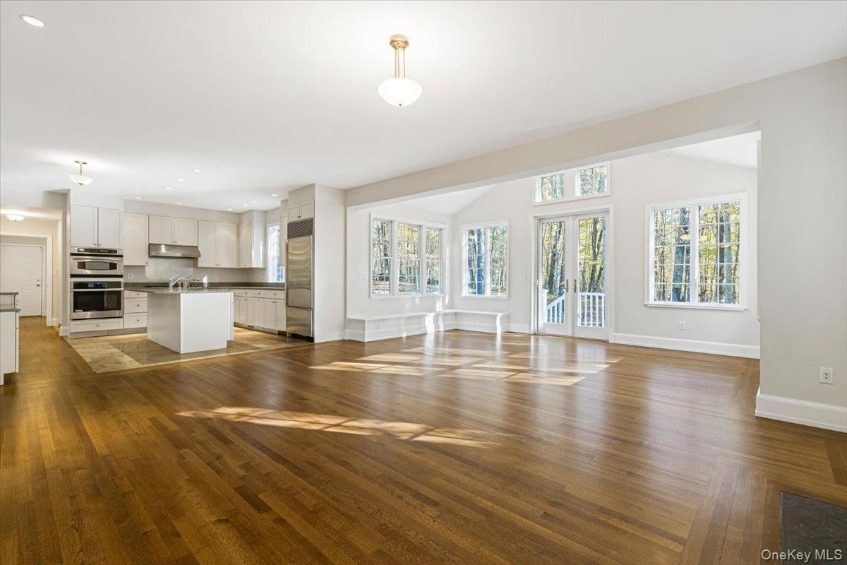 Empty room, Interior, Kitchen, Recessed Lighting, Stainless Steel Appliances, Wood Texture Flooring