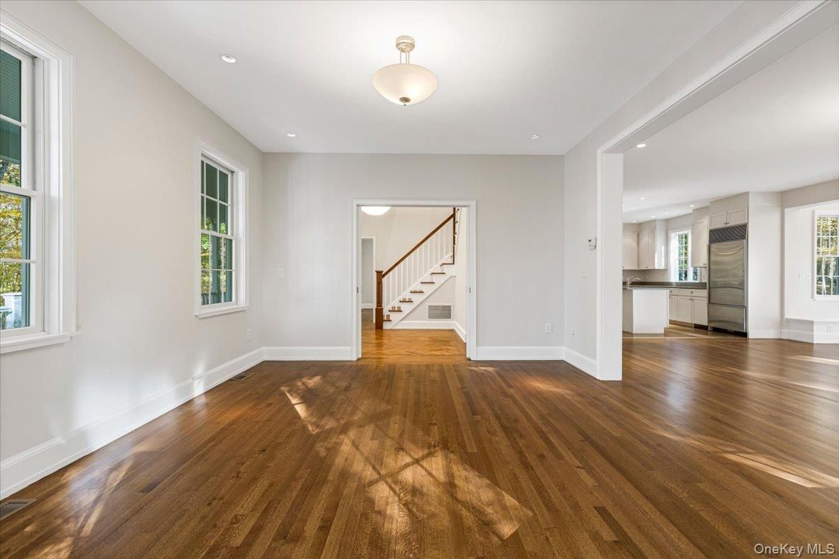 Empty room, Interior, Kitchen, Recessed Lighting, Stainless Steel Appliances, Wood Texture Flooring