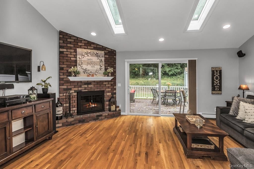 Fireplace, Interior, Living room, Recessed Lighting, Stone Walls, Wood Texture Flooring