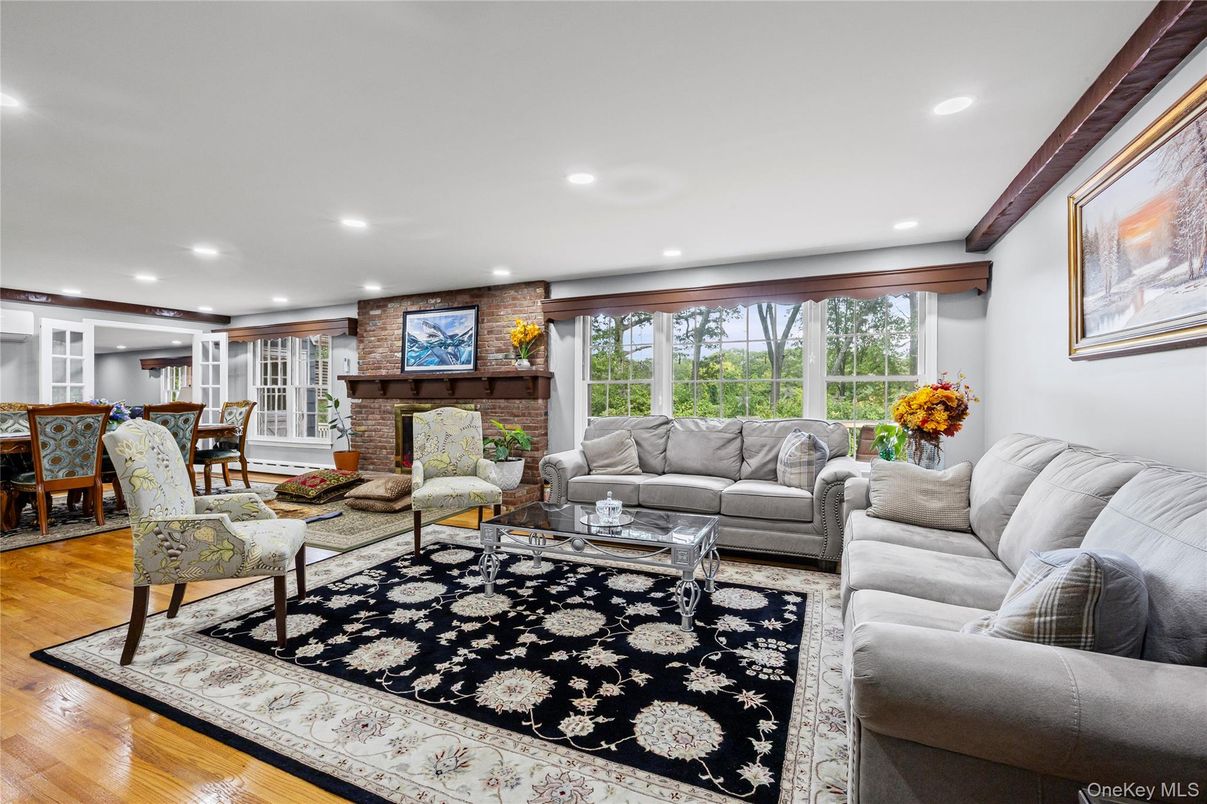 Dining room, Fireplace, Interior, Living room, Recessed Lighting, Stone Walls, Wood Texture Flooring