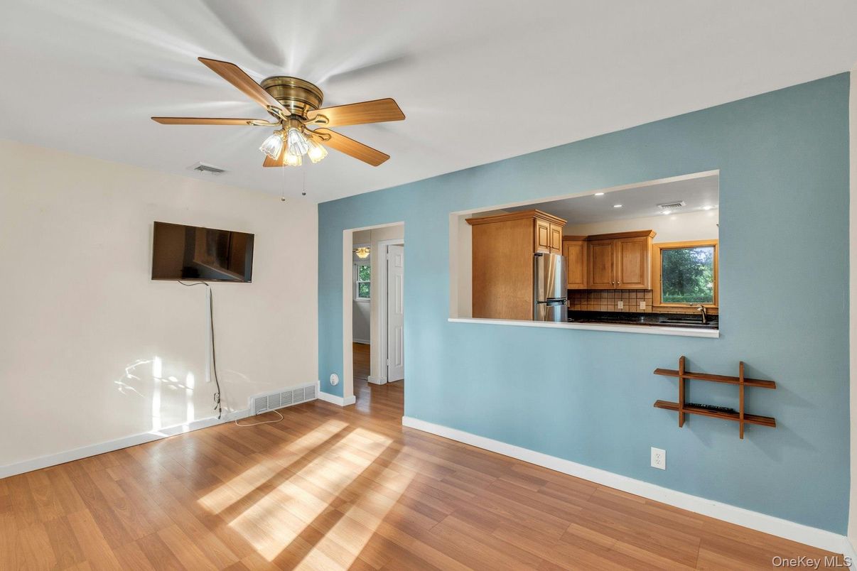 Empty room, Interior, Kitchen, Recessed Lighting, Stainless Steel Appliances, Wood Texture Flooring