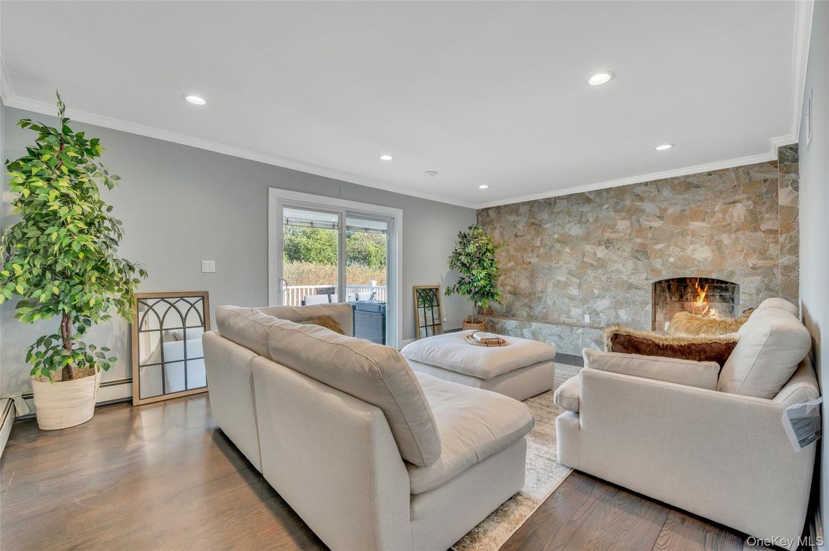 Fireplace, Interior, Living room, Recessed Lighting, Stone Walls, Wood Texture Flooring