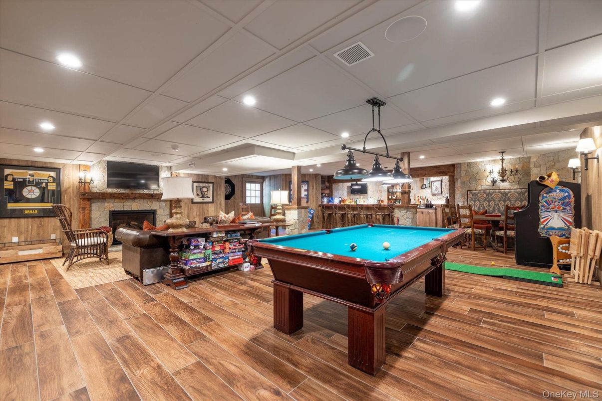 Billiard Table, Fireplace, Game Room, Interior, Pendant Lights, Recessed Lighting, Stone Walls, Wood Texture Flooring, Wooden Walls
