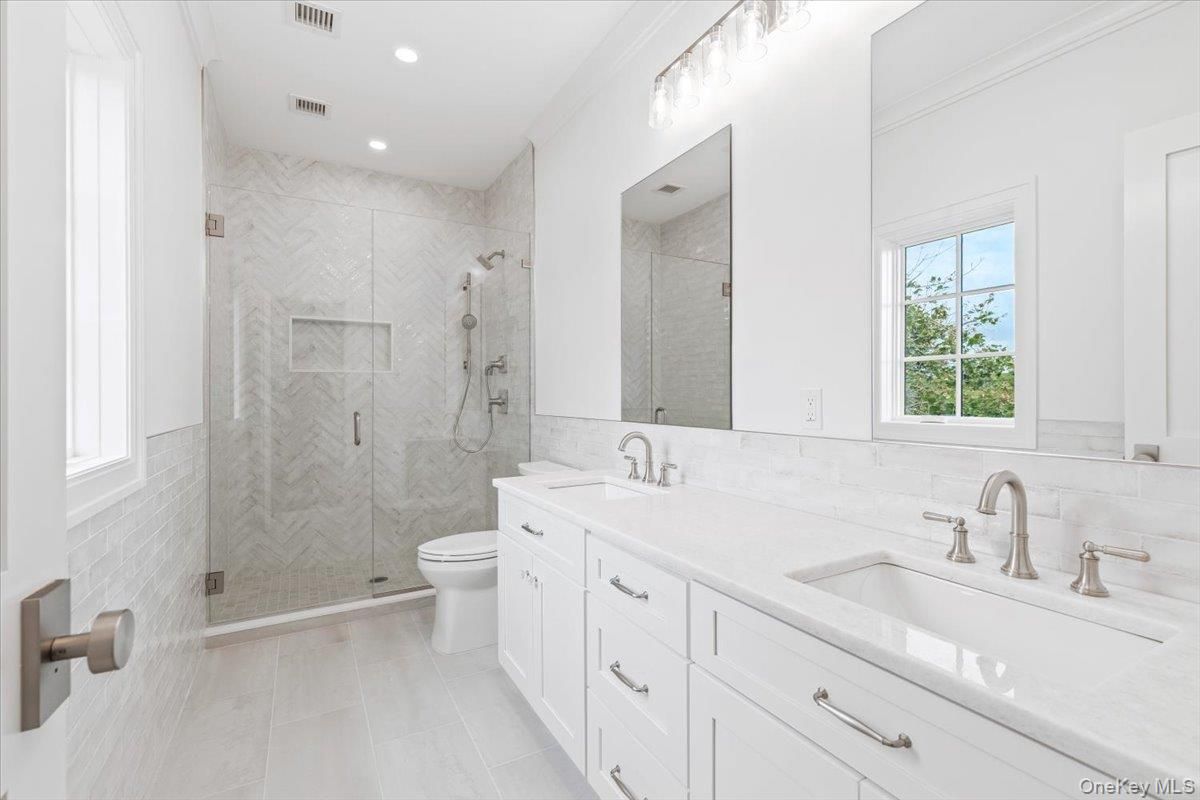 Bathroom, Dual Sink Vanities, Glass Shower, Interior, Marble Walls, Recessed Lighting