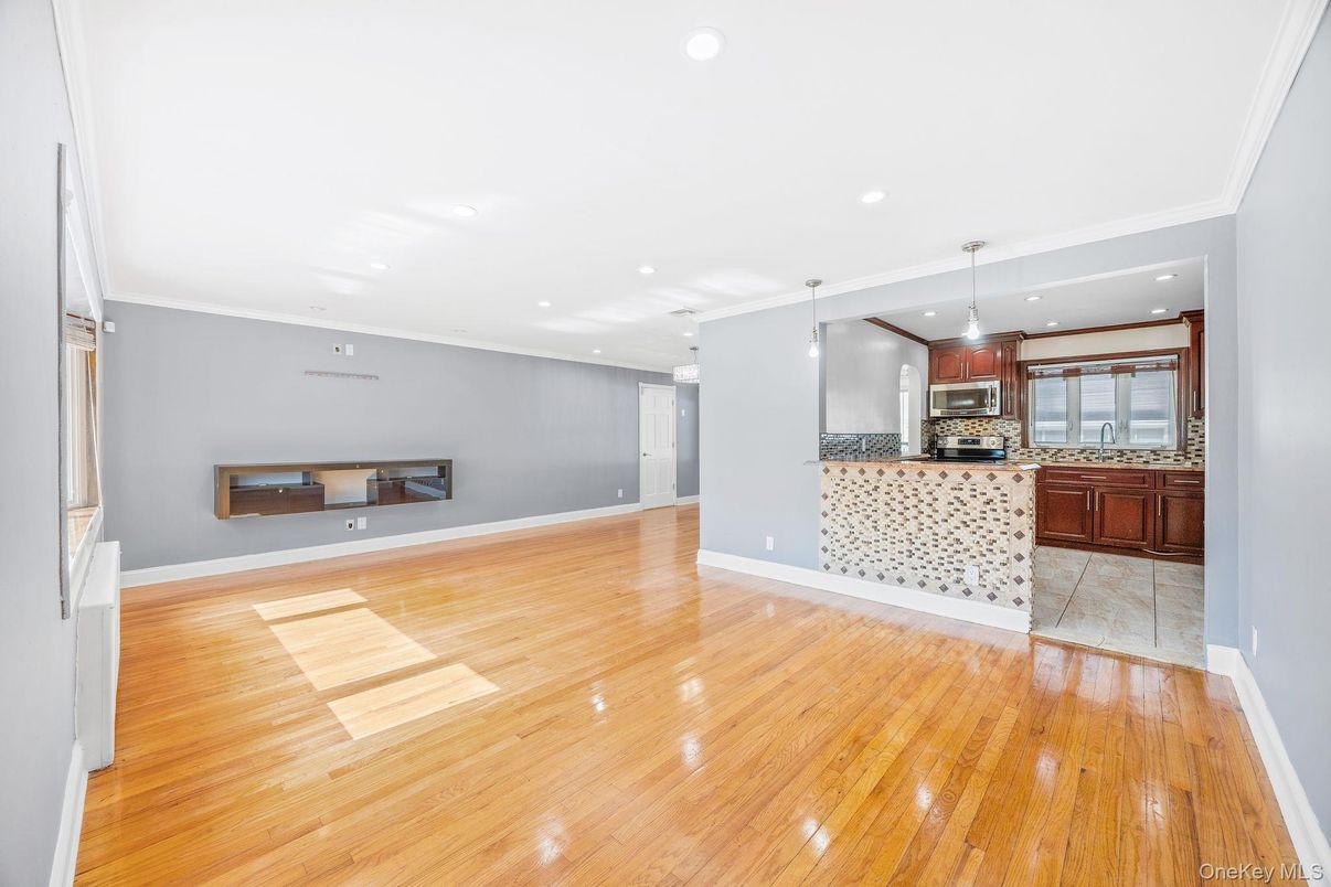 Empty room, Interior, Kitchen, Pendant Lights, Recessed Lighting, Stainless Steel Appliances, Wood Texture Flooring