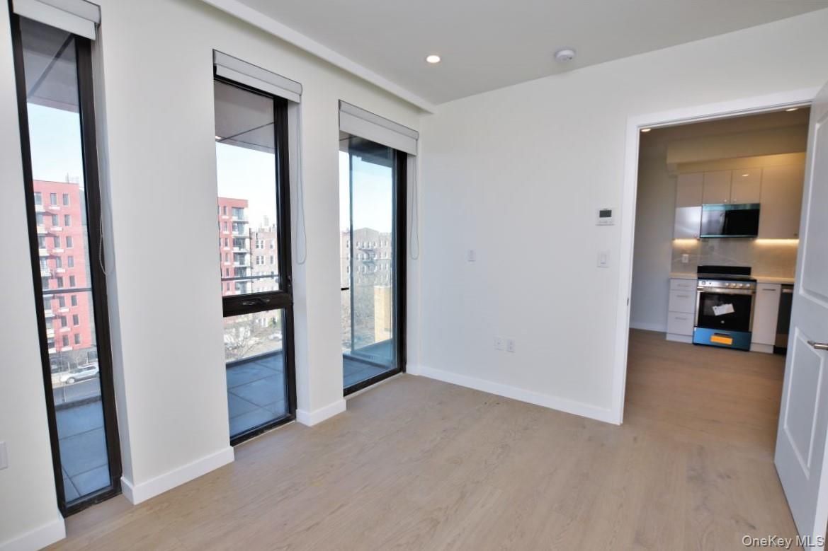 Empty room, Interior, Kitchen, Recessed Lighting, Stainless Steel Appliances, Wood Texture Flooring