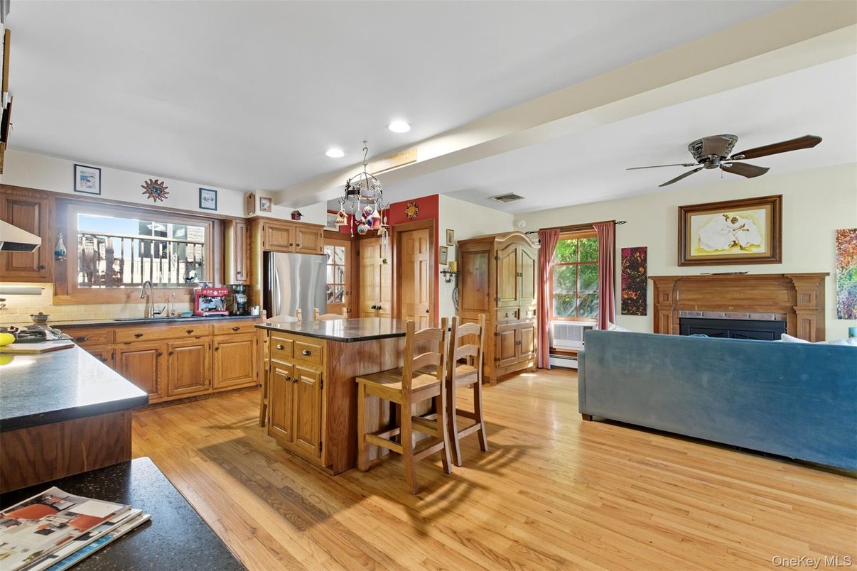 Chandelier, Fireplace, Interior, Kitchen, Recessed Lighting, Stainless Steel Appliances, Wood Texture Flooring