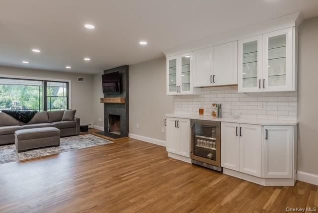 Fireplace, Interior, Kitchen, Living room, Recessed Lighting, Stainless Steel Appliances, Wood Texture Flooring