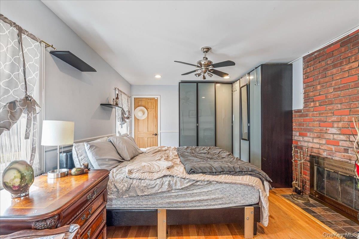 Bedroom, Fireplace, Interior, Recessed Lighting, Stone Walls, Wood Texture Flooring