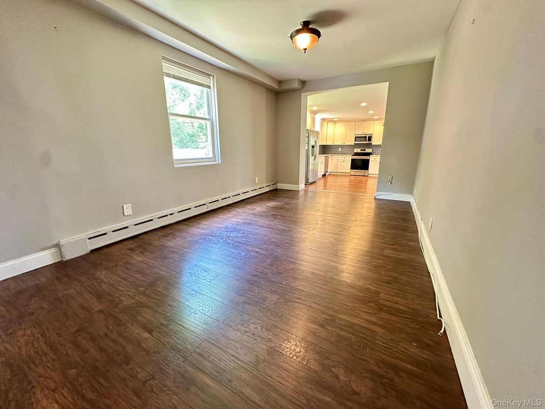 Empty room, Interior, Kitchen, Recessed Lighting, Stainless Steel Appliances, Wood Texture Flooring