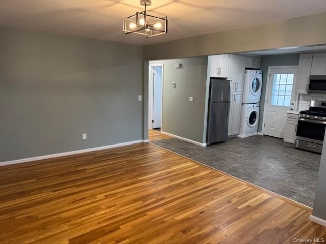 Empty room, Interior, Kitchen, Pendant Lights, Stainless Steel Appliances, Washer, Wood Texture Flooring
