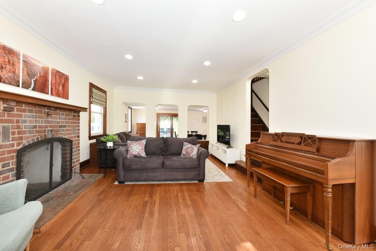 Fireplace, Interior, Living room, Piano, Recessed Lighting, Stone Walls, Wood Texture Flooring