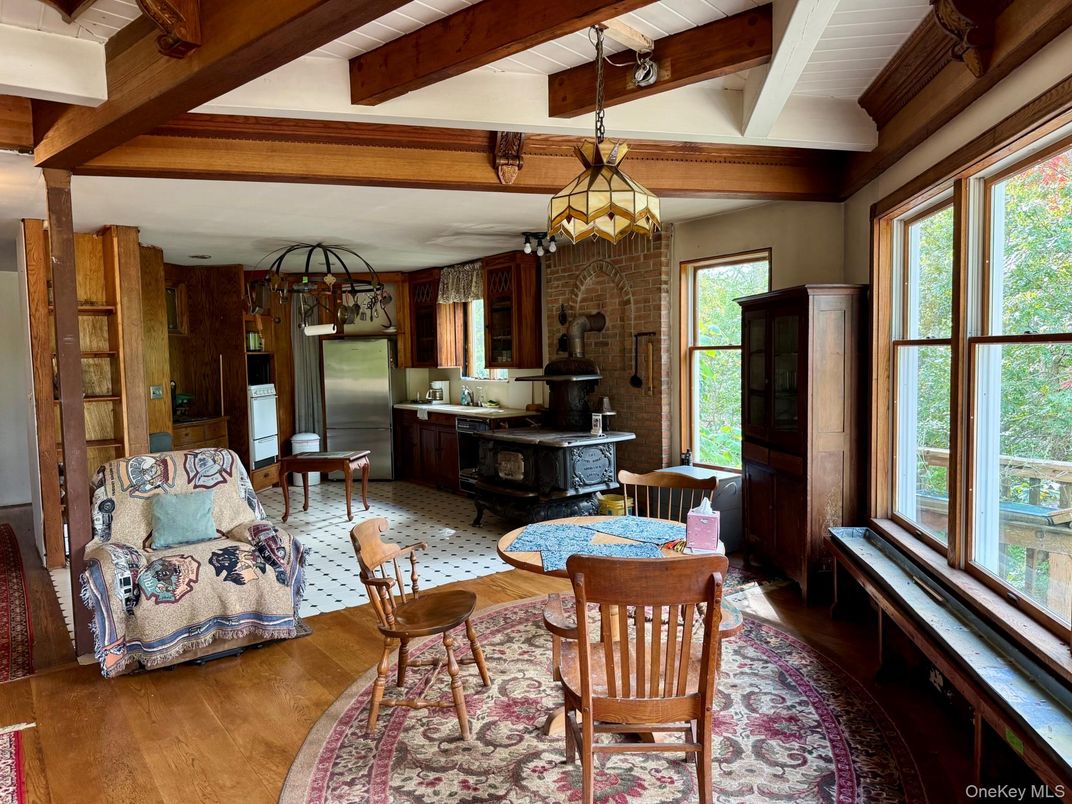 Chandelier, Dining room, Interior, Kitchen, Pendant Lights, Stainless Steel Appliances, Stone Walls, Wooden Beams, Wood Texture Flooring
