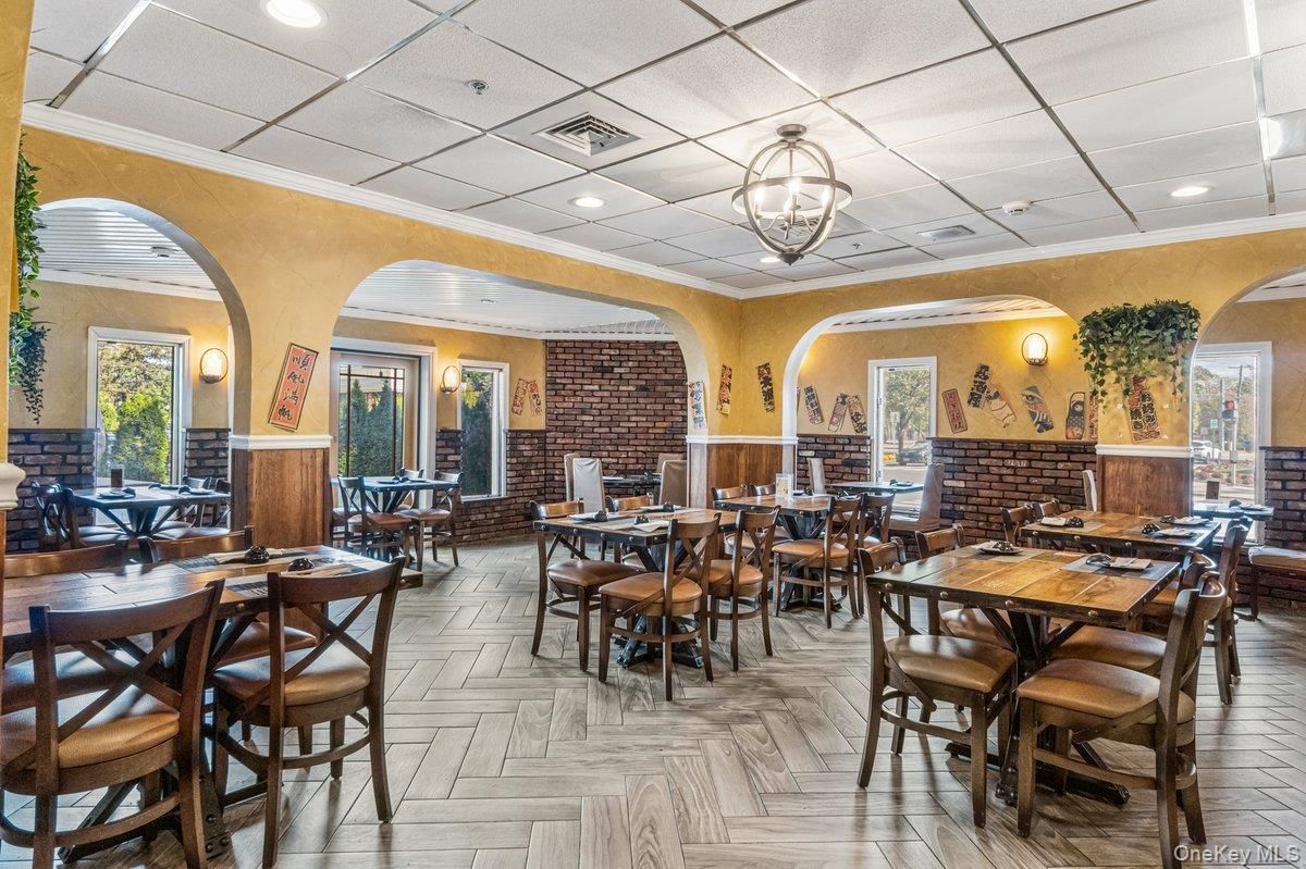 Dining room, Fireplace, Interior, Recessed Lighting, Stone Walls, Wood Texture Flooring