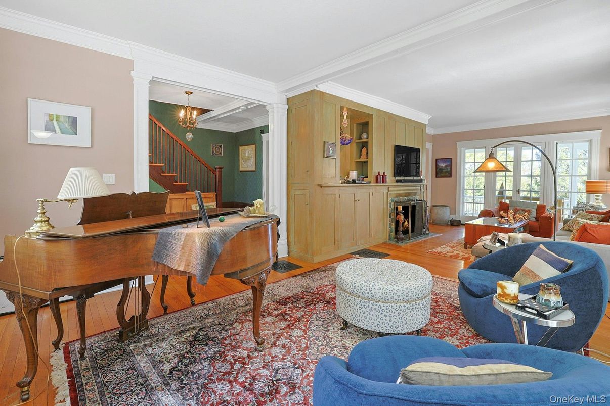 Chandelier, Dining room, Fireplace, Interior, Living room, Pendant Lights, Piano, Wood Texture Flooring