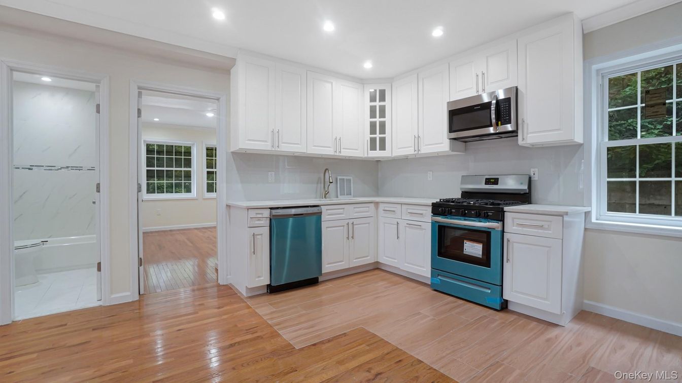 Interior, Kitchen, Marble Walls, Recessed Lighting, Stainless Steel Appliances, Wood Texture Flooring