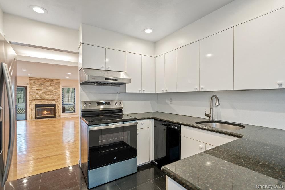 Fireplace, Interior, Kitchen, Recessed Lighting, Stainless Steel Appliances, Stone Walls, Wood Texture Flooring