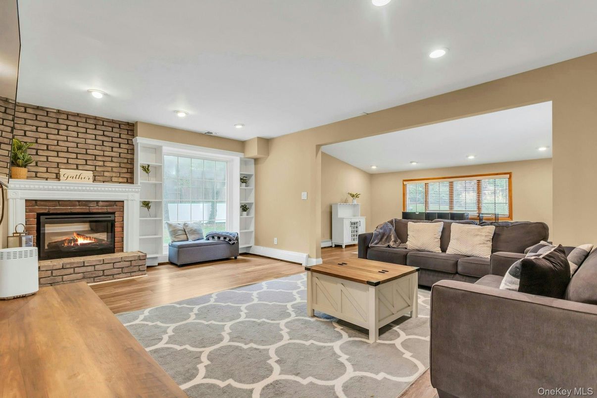 Fireplace, Interior, Living room, Recessed Lighting, Stone Walls, Wood Texture Flooring