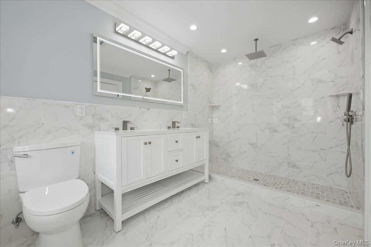 Bathroom, Dual Sink Vanities, Glass Shower, Interior, Marble, Marble Walls, Recessed Lighting