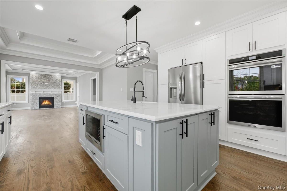 Fireplace, Interior, Kitchen, Pendant Lights, Recessed Lighting, Stainless Steel Appliances, Wood Texture Flooring