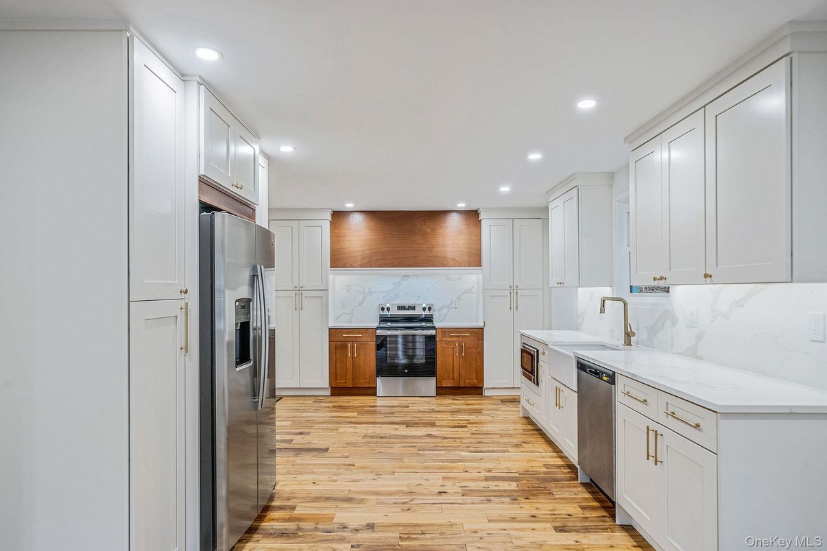 Interior, Kitchen, Marble Walls, Recessed Lighting, Stainless Steel Appliances, Wood Texture Flooring