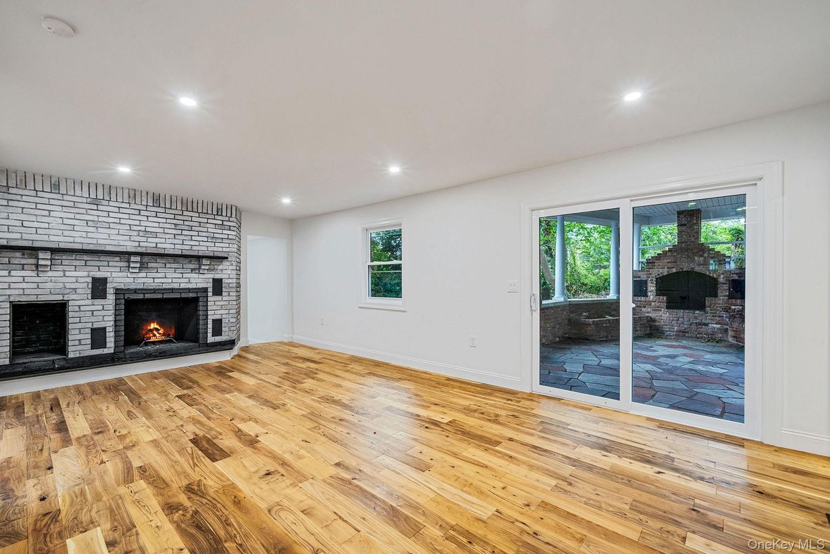 Empty room, Fireplace, Interior, Recessed Lighting, Stone Walls, Wood Texture Flooring