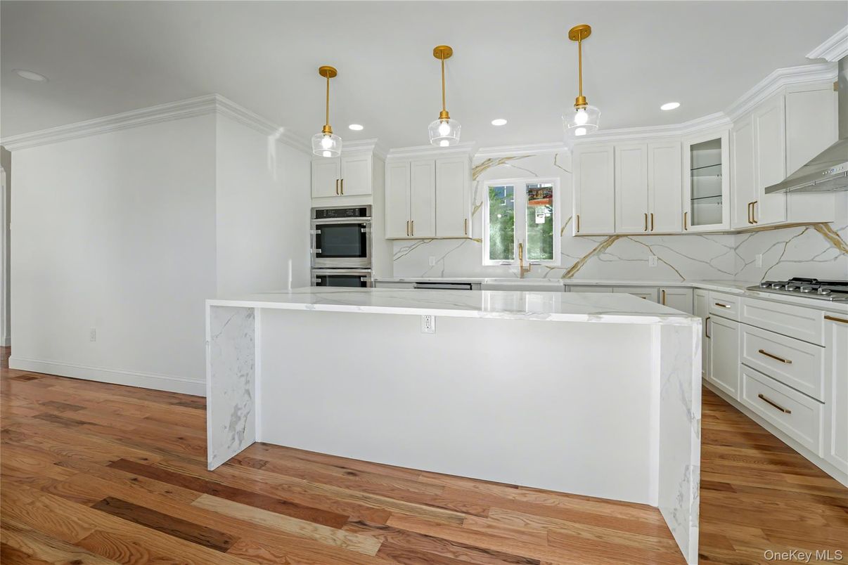 Interior, Kitchen, Marble Walls, Pendant Lights, Recessed Lighting, Stainless Steel Appliances, Wood Texture Flooring