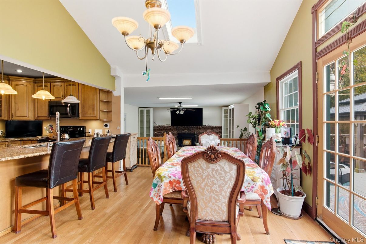 Chandelier, Dining room, Fireplace, Interior, Kitchen, Recessed Lighting, Stone Walls, Wood Texture Flooring