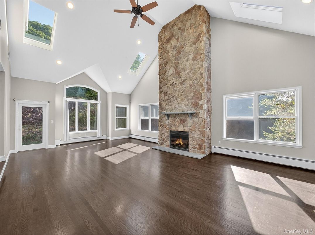 Empty room, Fireplace, Interior, Recessed Lighting, Stone Walls, Wood Texture Flooring